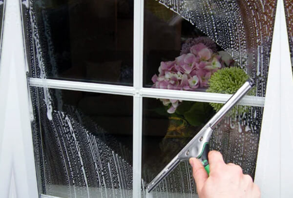 Window cleaning in Epsom before clean with dull marked glass